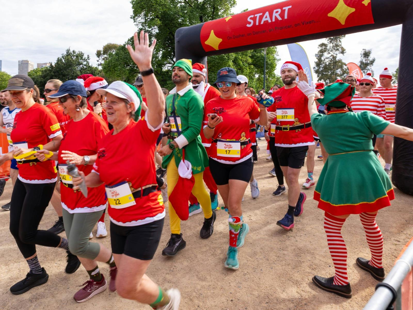 Participants running through the start gantry at Santa Fun Run