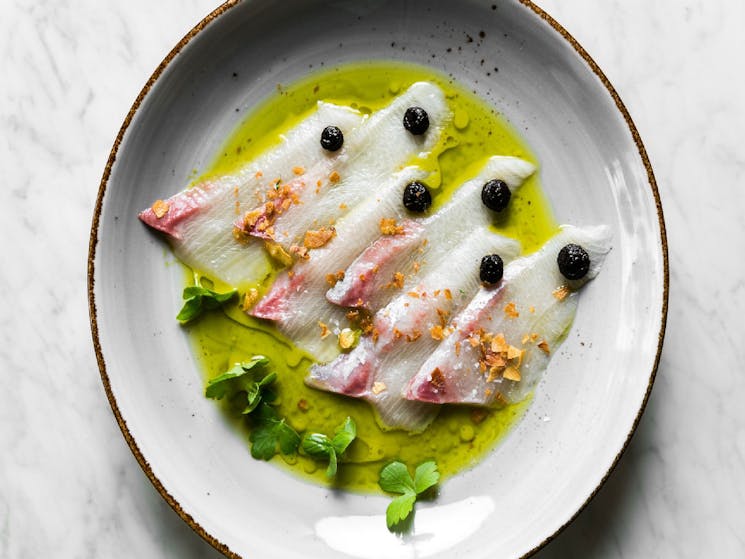 Kingfish Crudo with black garlic, parsley and lemon