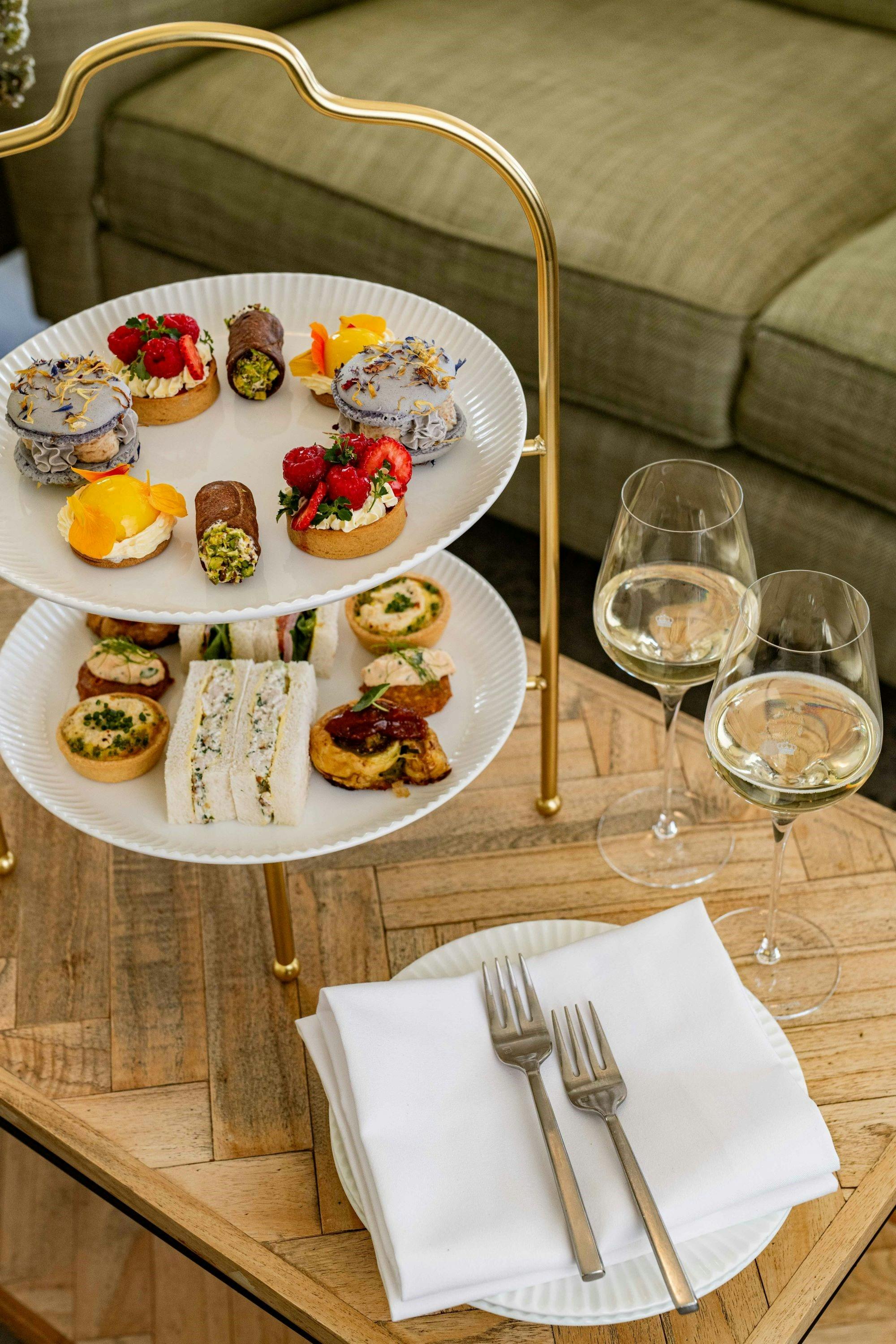 Image of a high tea stand with canape style food and champagne glasses