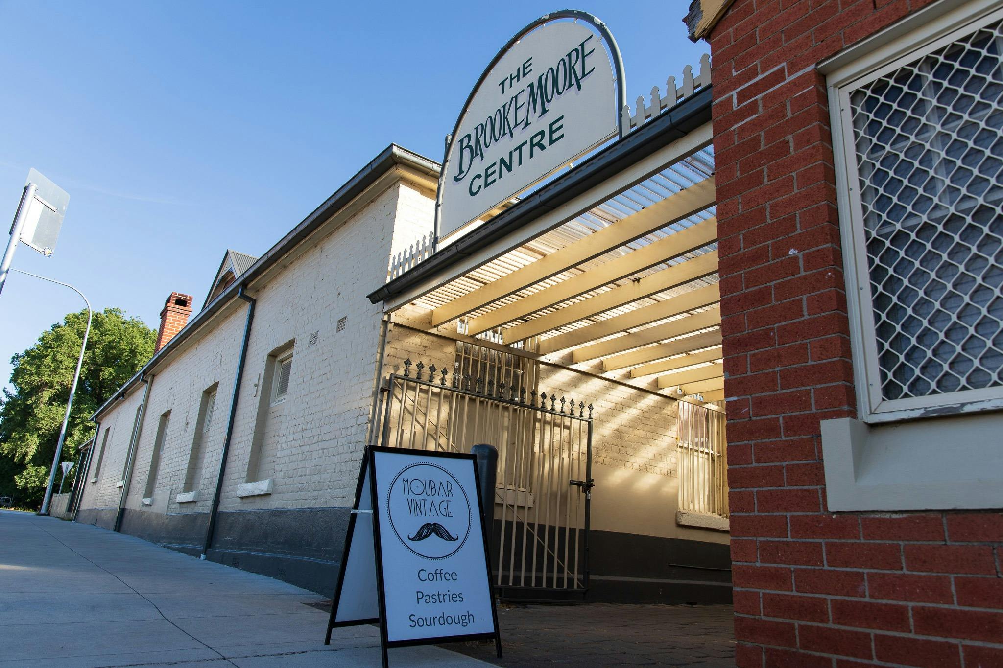 An open sigh for Moubar Vintage outside of the courtyard entrance at the Brooke Moore Centre