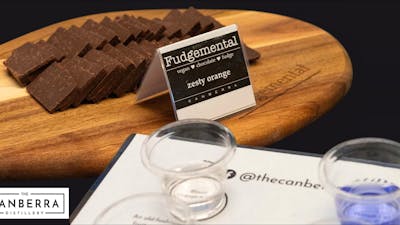 fudge on a wooden platter and tasting glasses of gin