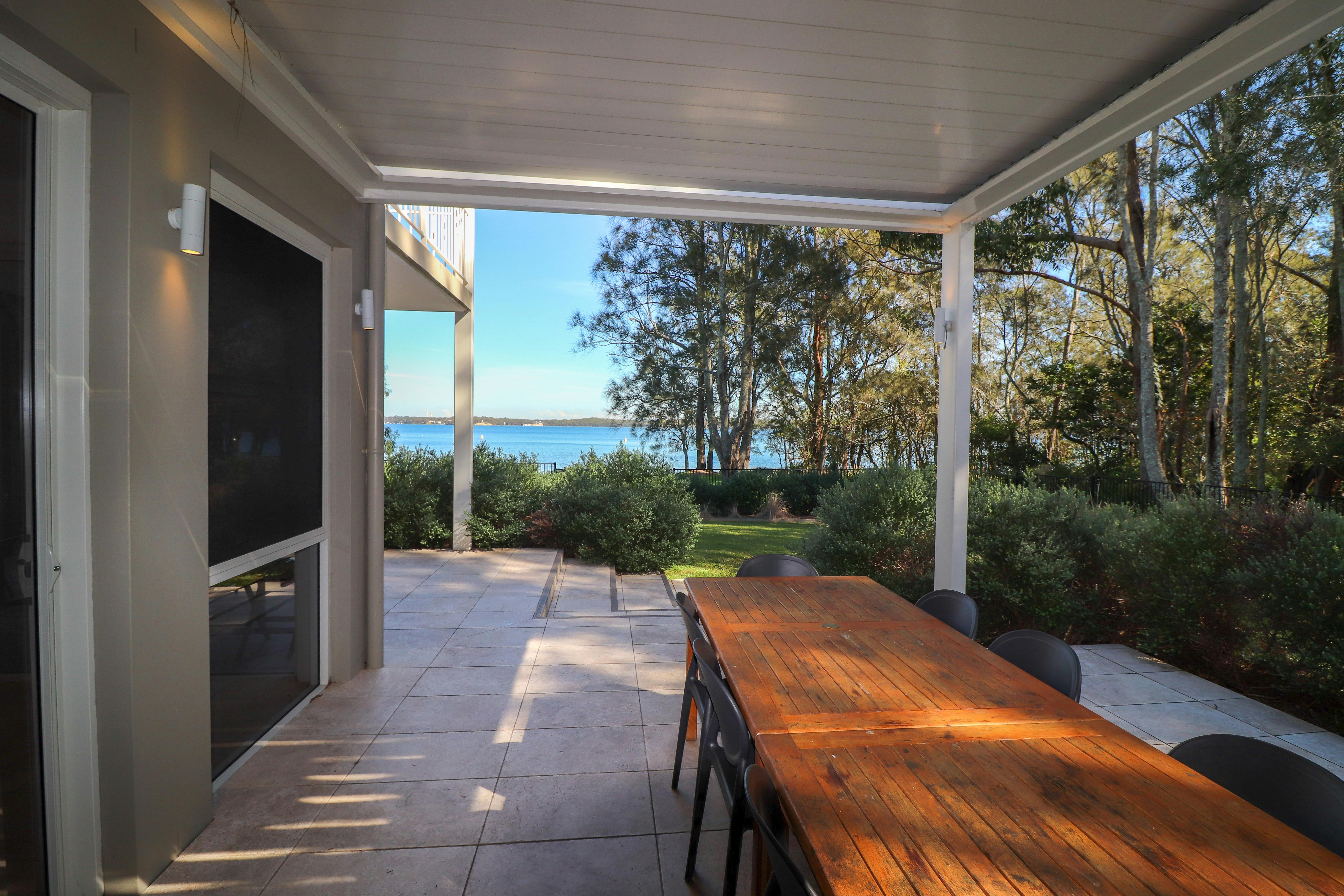 Undercover eating area and barbecue with water views