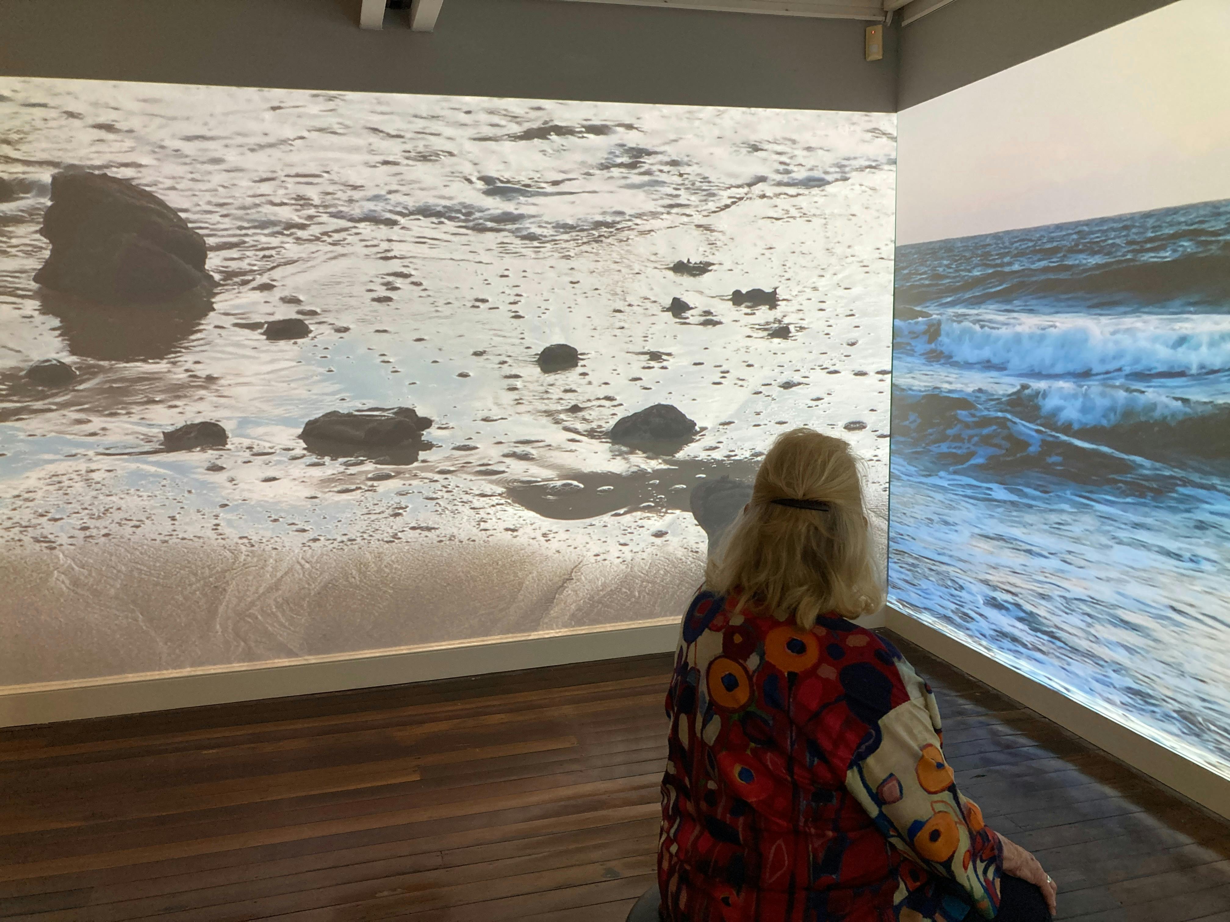 woman watching beach scenes in Birpai Country Stories