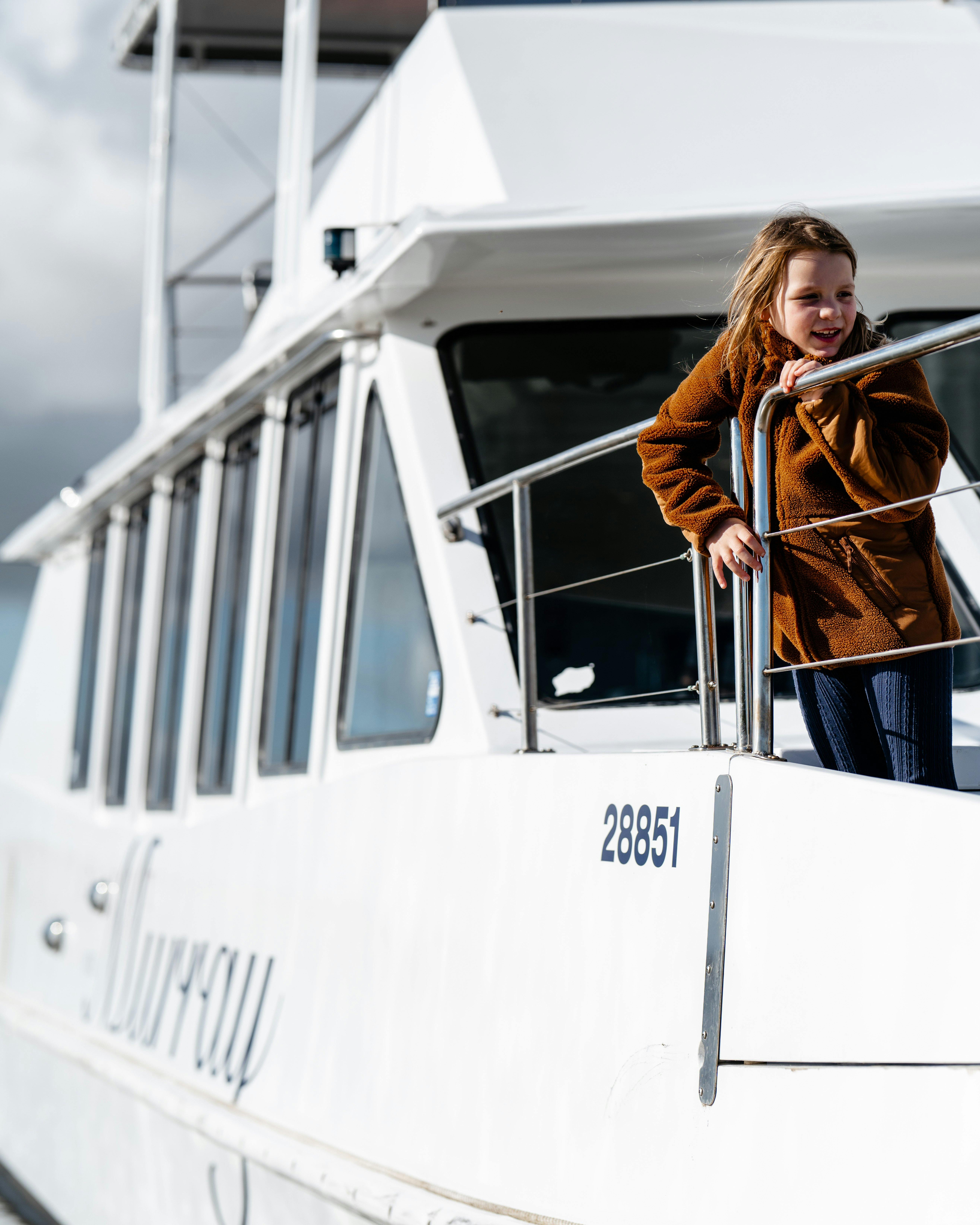 Child enjoying their cruise as they watch from the front of the vessel.