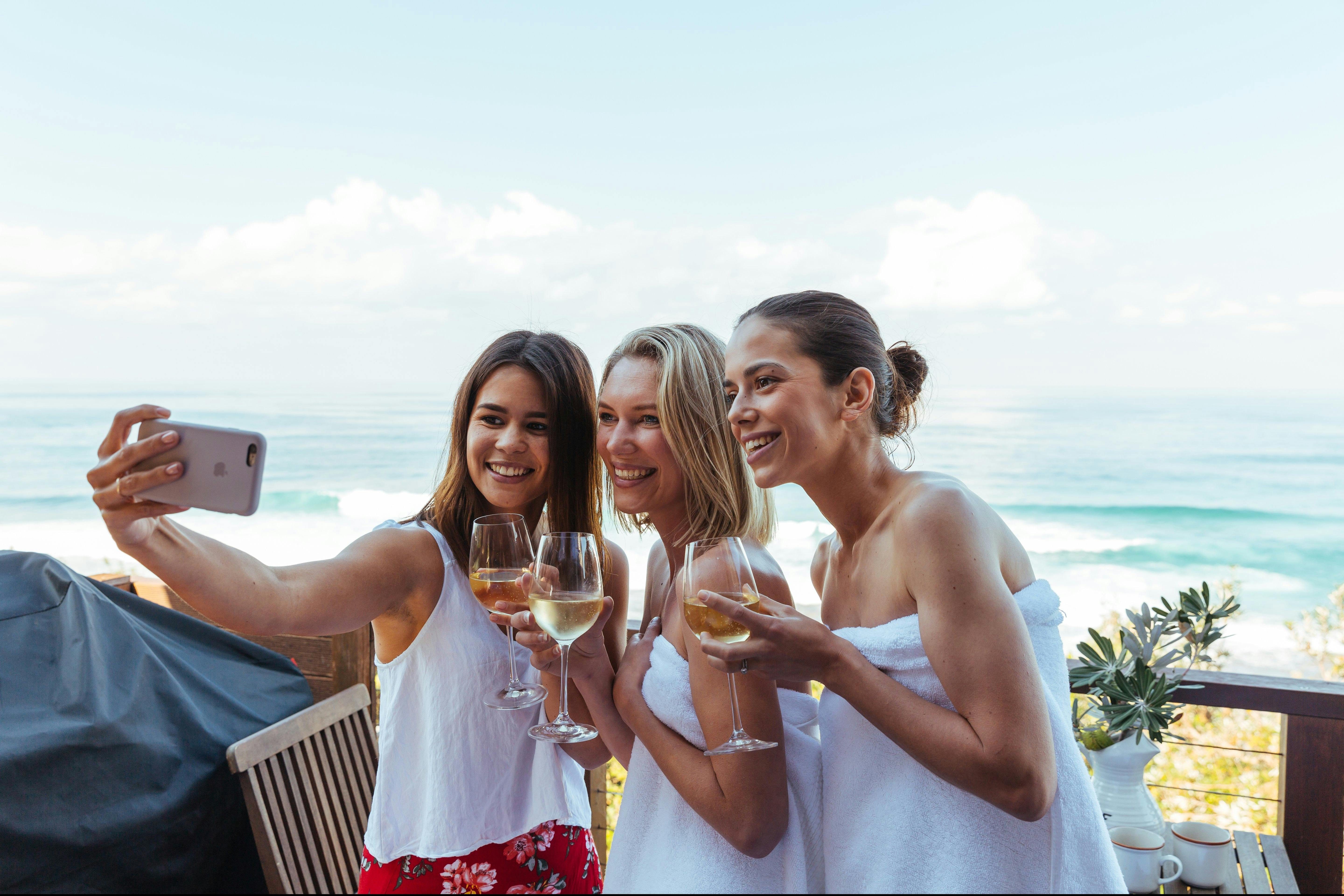 Three women taking a selfie in at a beachfront property