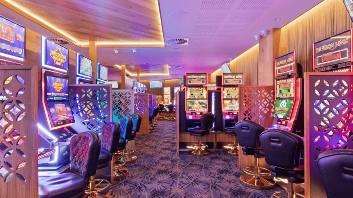 Gaming room with modern layout with a large selection of gaming machines soft lighting