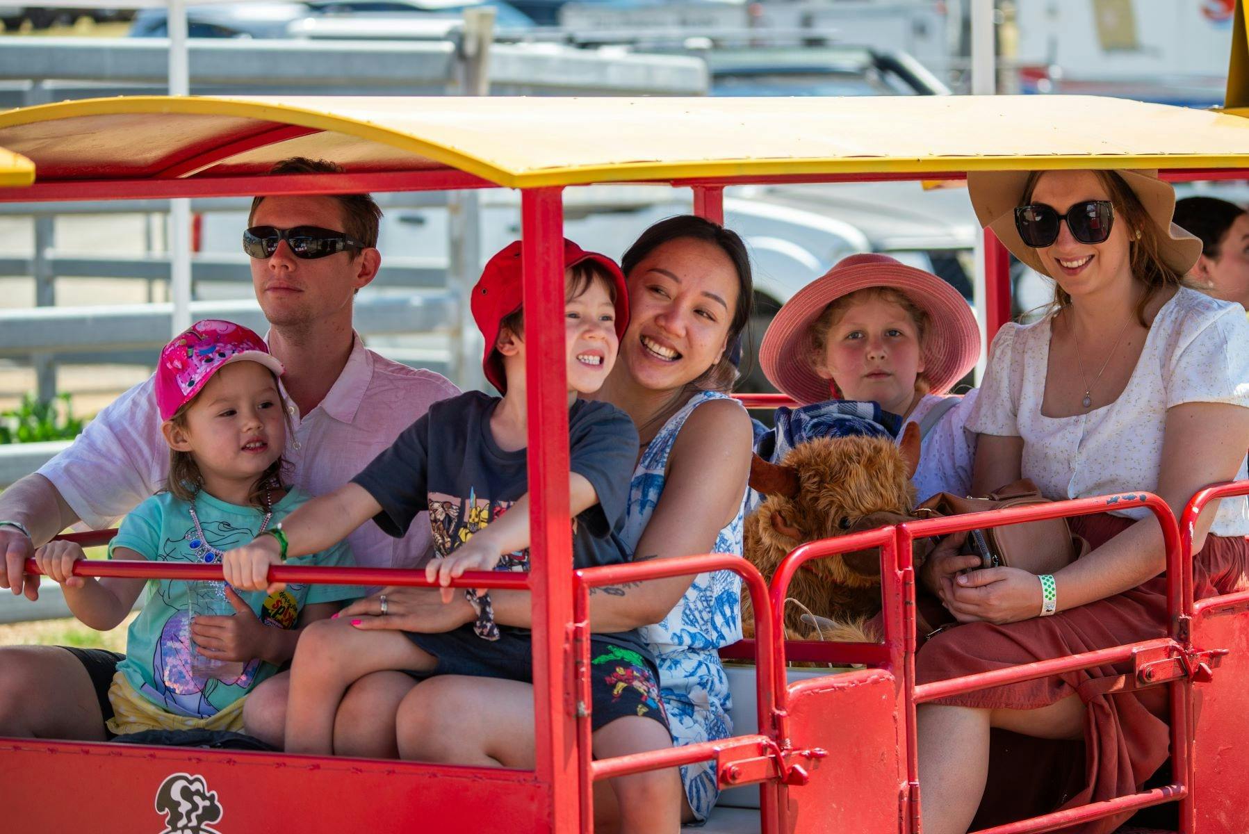 Happy children and parents on a mini-train