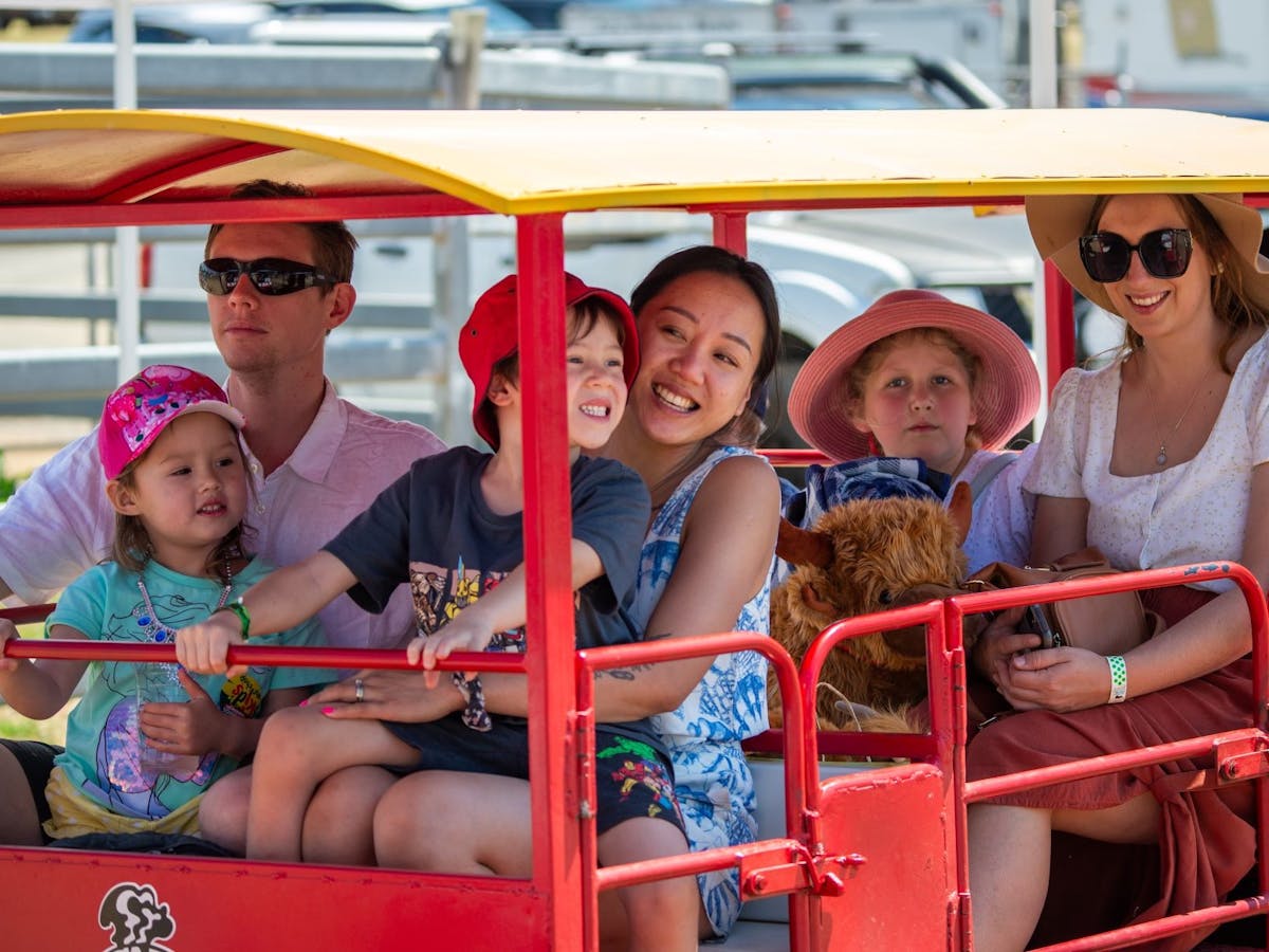 Happy children and parents on a mini-train