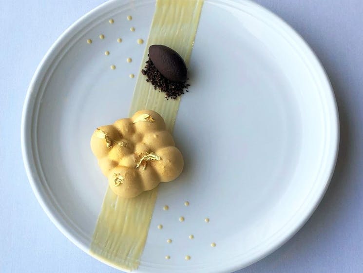 Caramel Delice with gold flecks and chocolate sorbet on plate