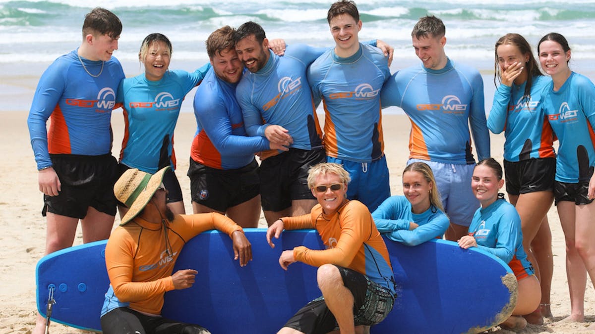 Fun group pic after completing their first surf lesson!