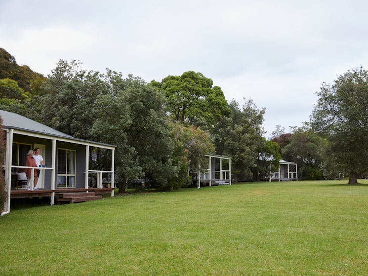 Cottages well spaced apart with trees between and all facing out onto a lawn