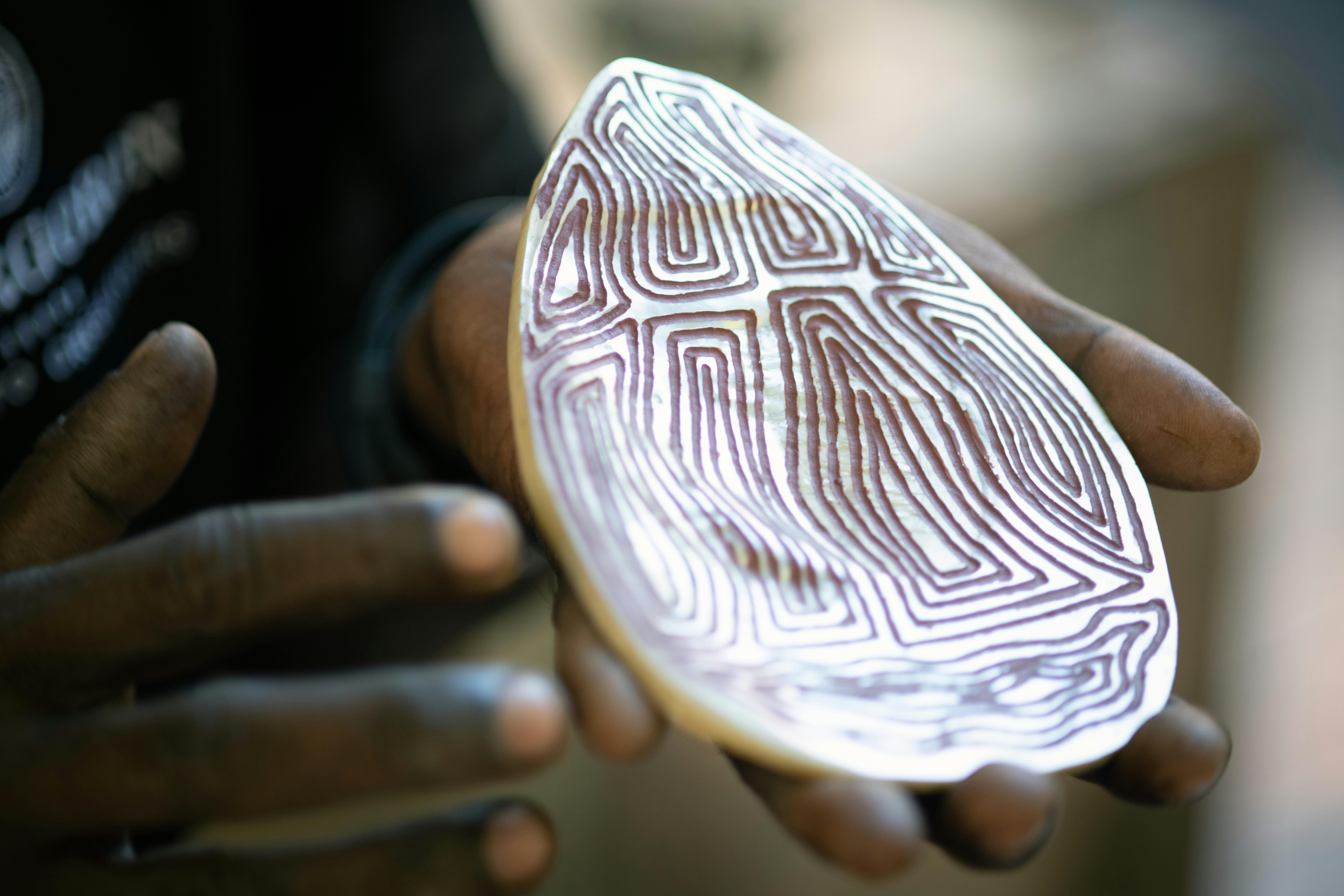 Terry Hunter holding carved pearl shell
