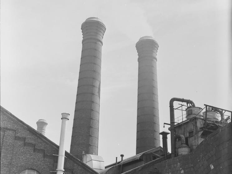 black and white photo of powerstation chimneys