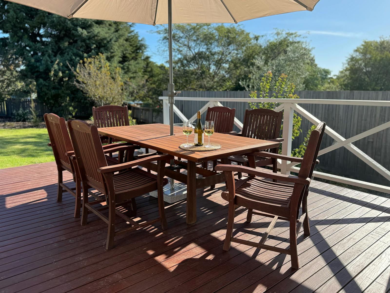 Large back deck at Calypso with BBQ and outdoor dining setting.