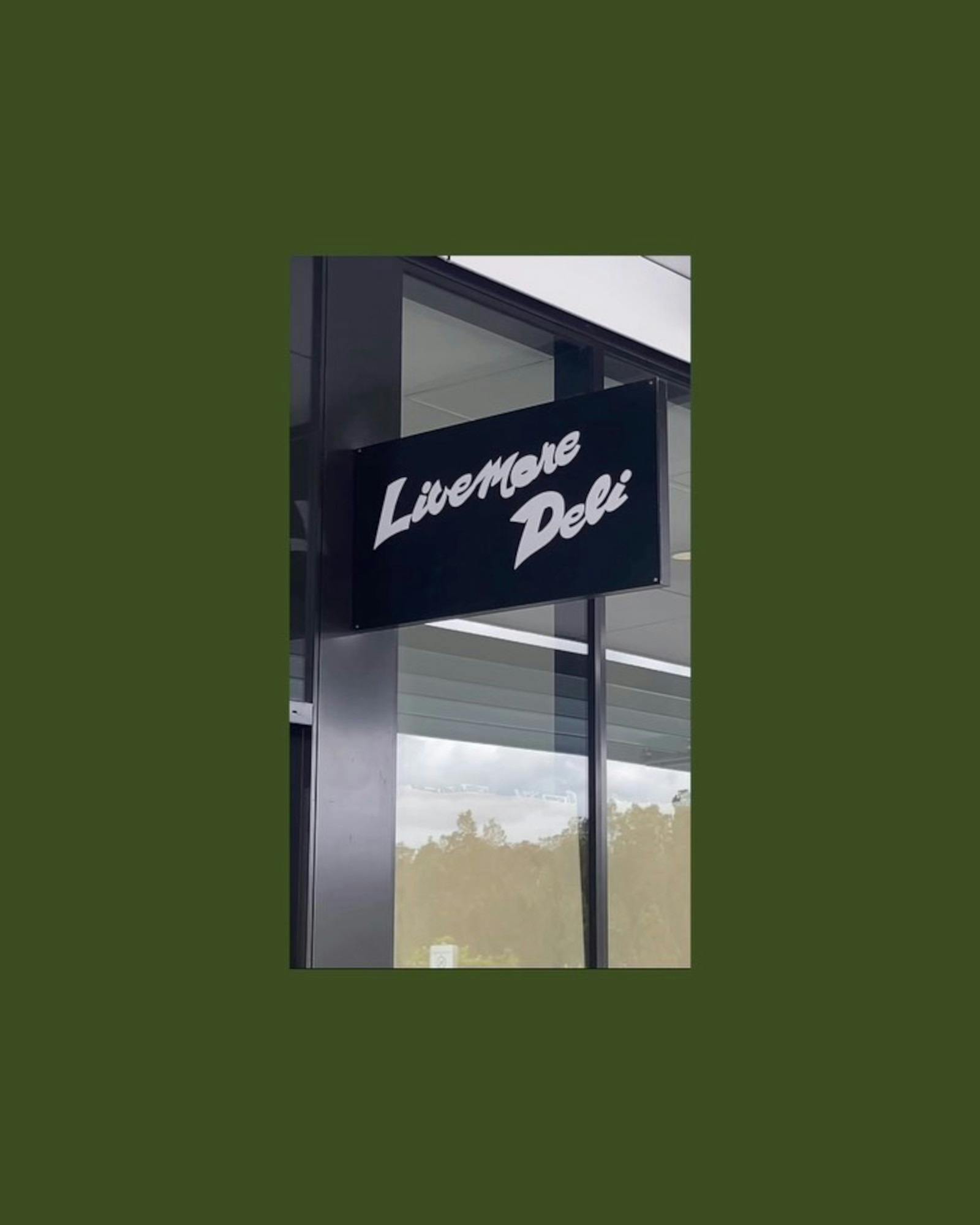 A sign on the outside of a shop saying 'Livemore Deli'