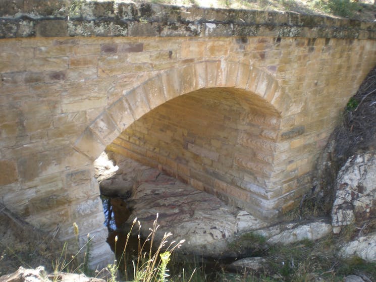 Brick structure shaped in an arch over a body of water