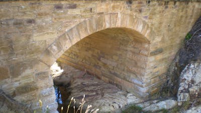 Brick structure shaped in an arch over a body of water