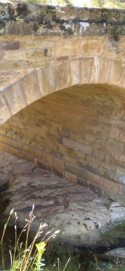 Brick structure shaped in an arch over a body of water