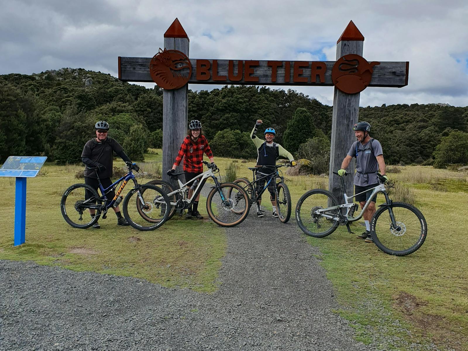 4 MTB riders shown at the trail head to the blue tier