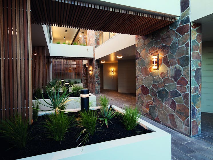 Outdoor corridor featuring a garden and slate tiles