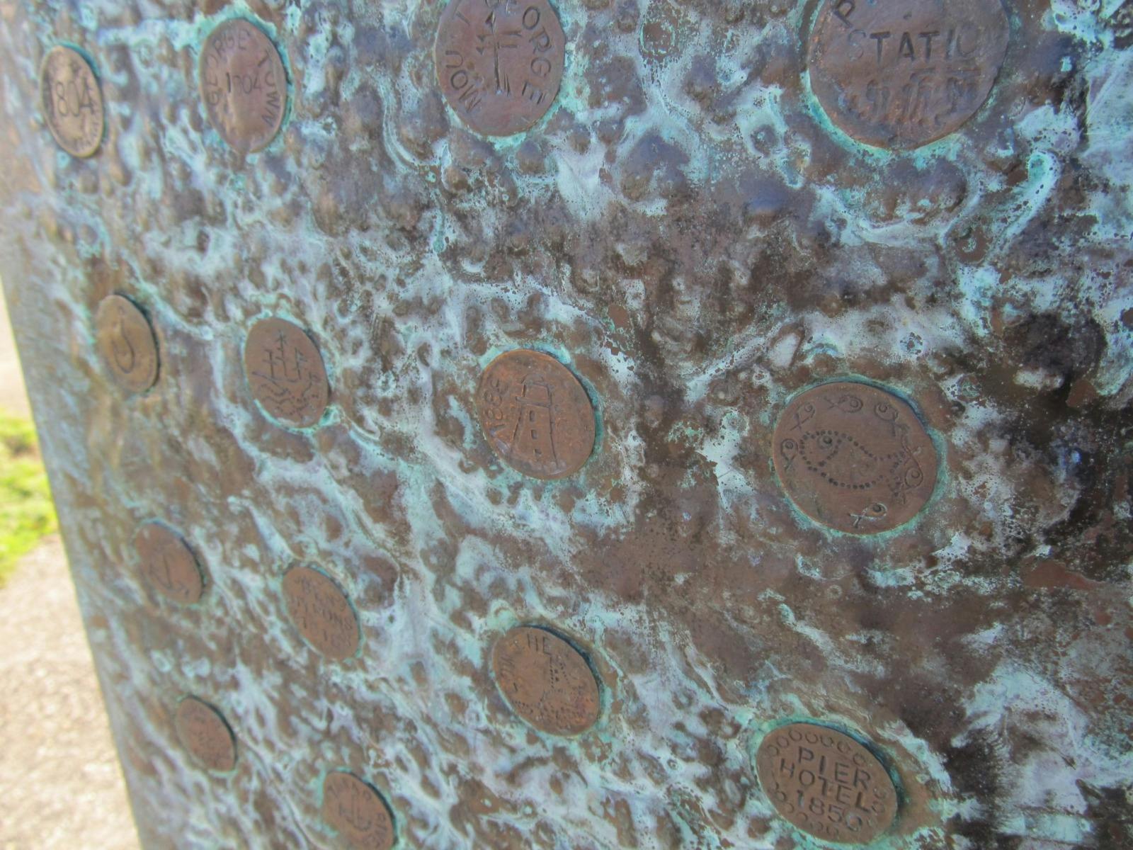 Copper discs , weathered brown , with greenish-blue verdigris