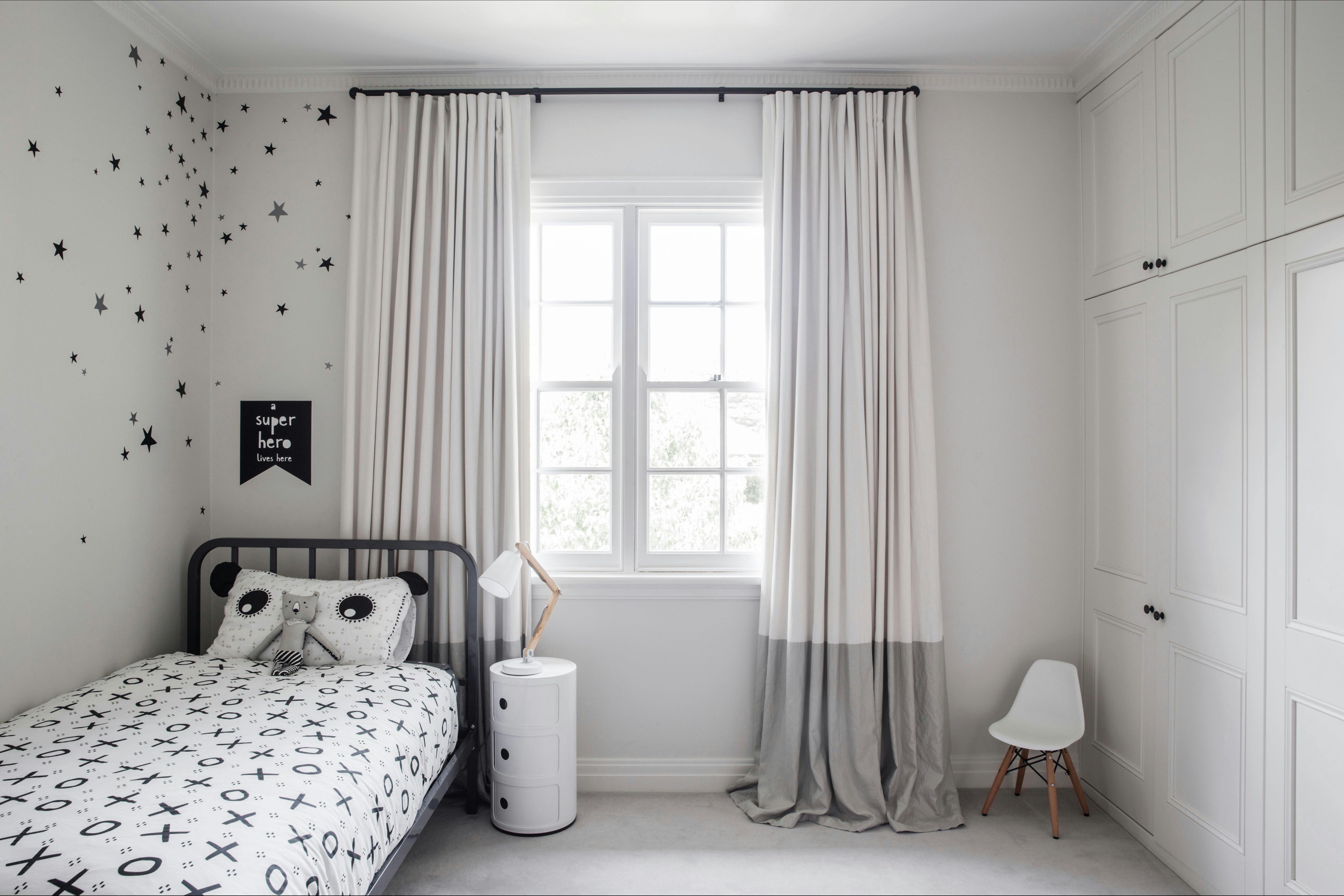 Single bed and a wall of cupboards