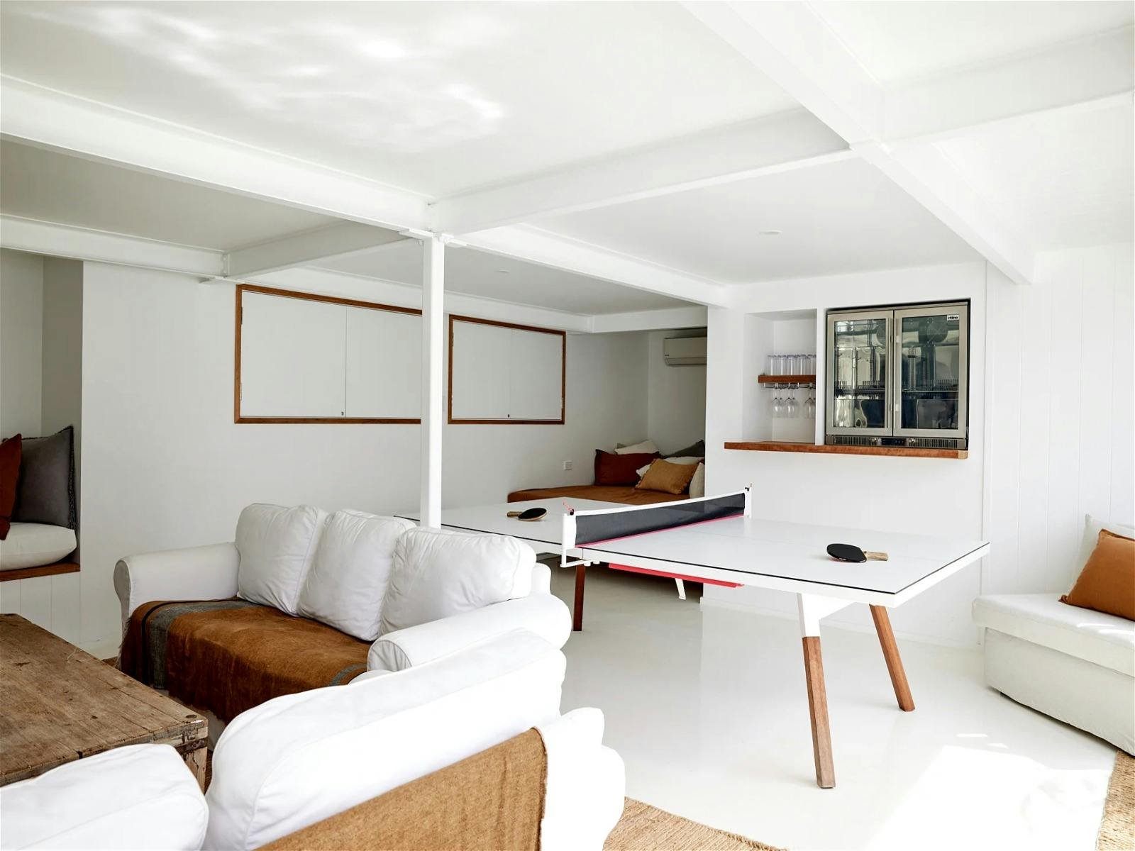 Spend for evenings in the games room with a bar fridge, designer ping pong table, lounges and a TV