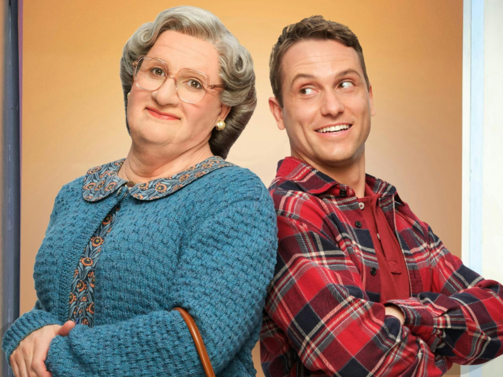 A photo of actor Jake Speer as Mrs Doubtfire and Daniel Hillard standing back to back