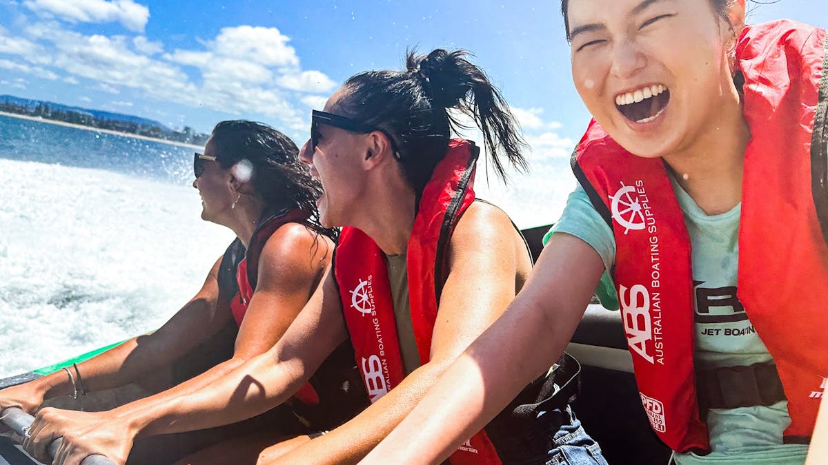 3 ladies wearing life jackets and smiling on Arro Jet Boat.