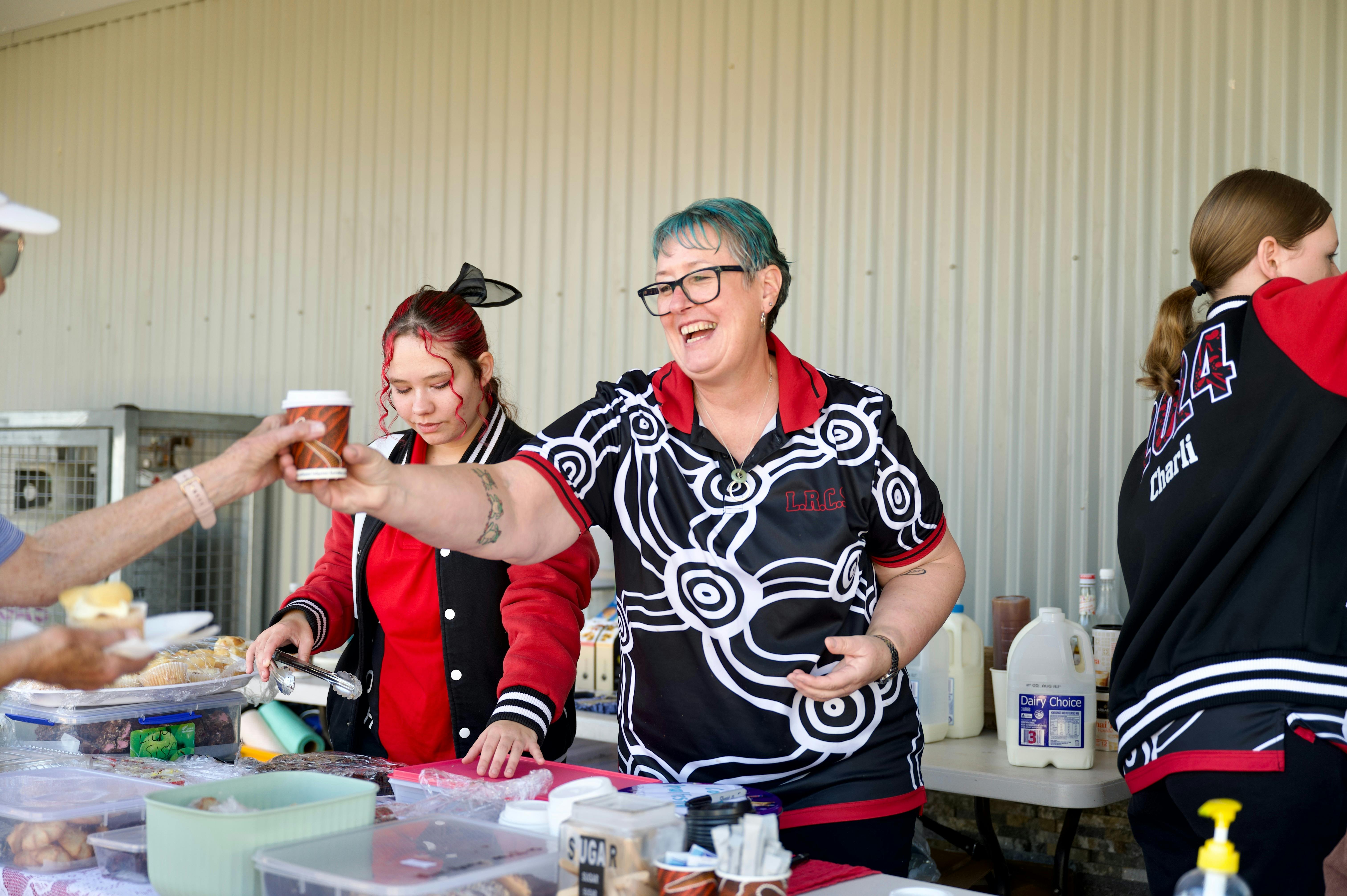The students serving up food from their student run food  stall