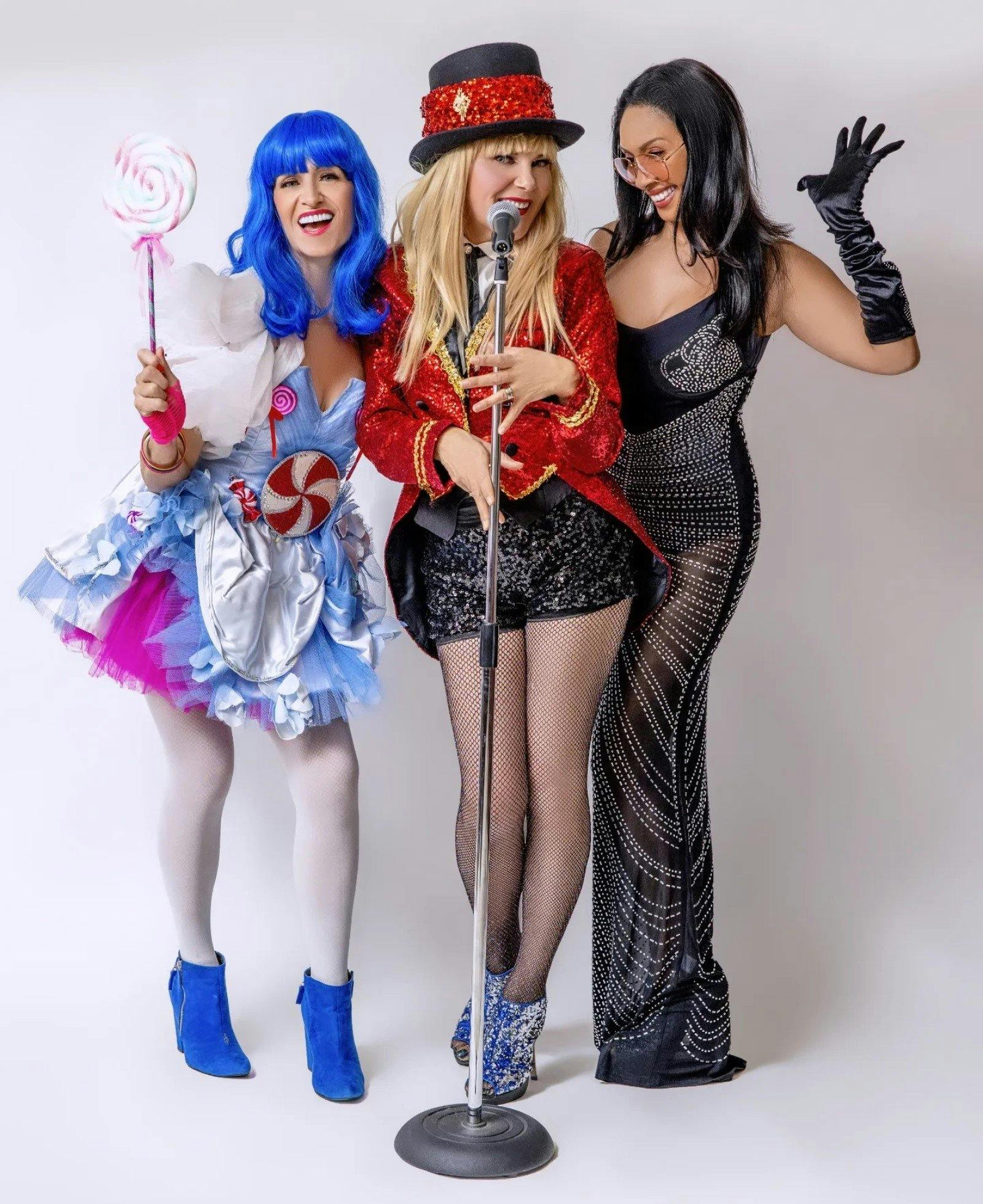 Three women dressed as pop stars