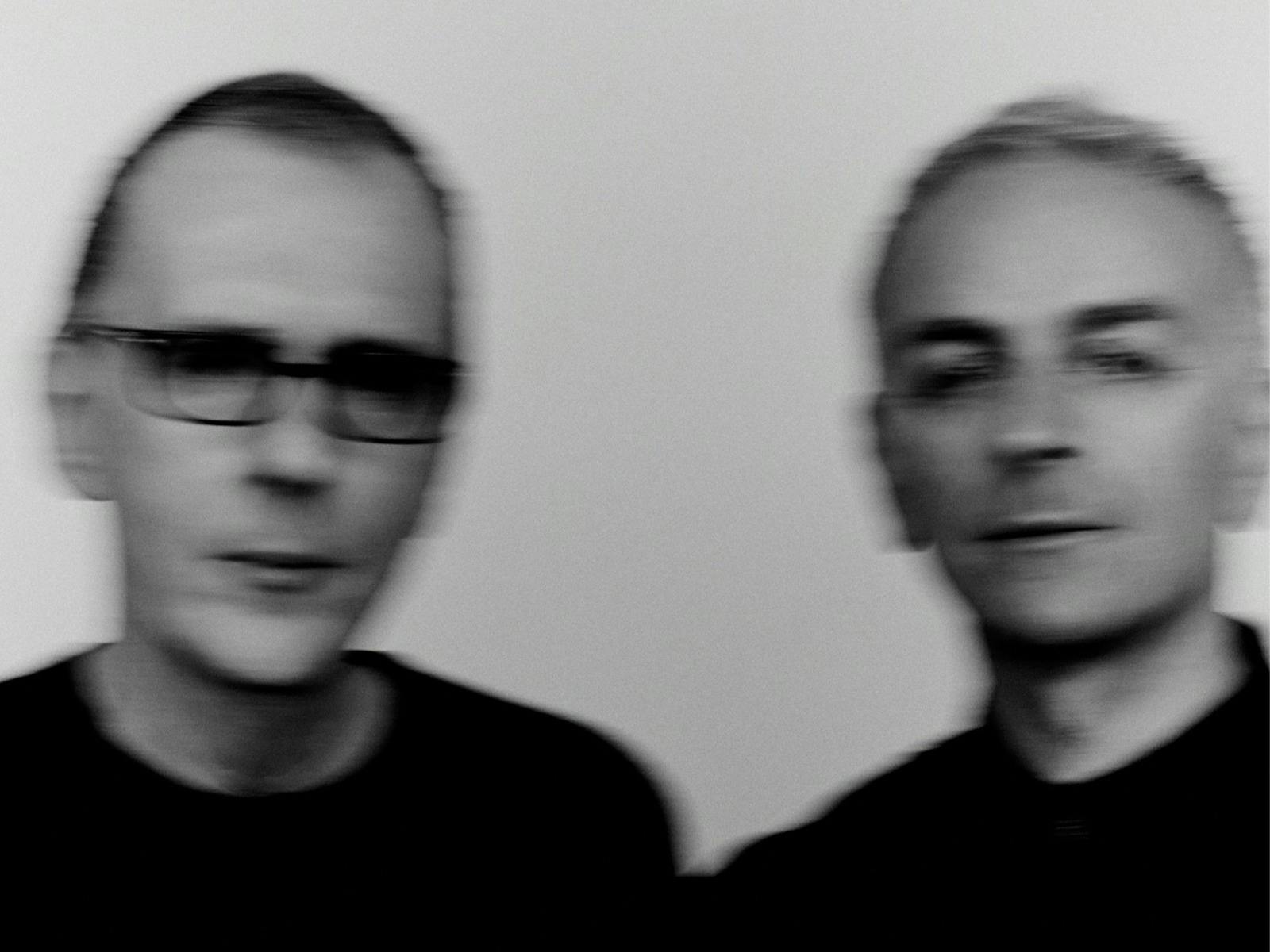 Artists Underworld looking at camera in black and white blurry image
