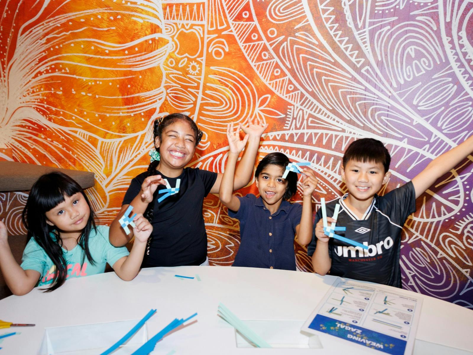 Four children enjoying craft activites