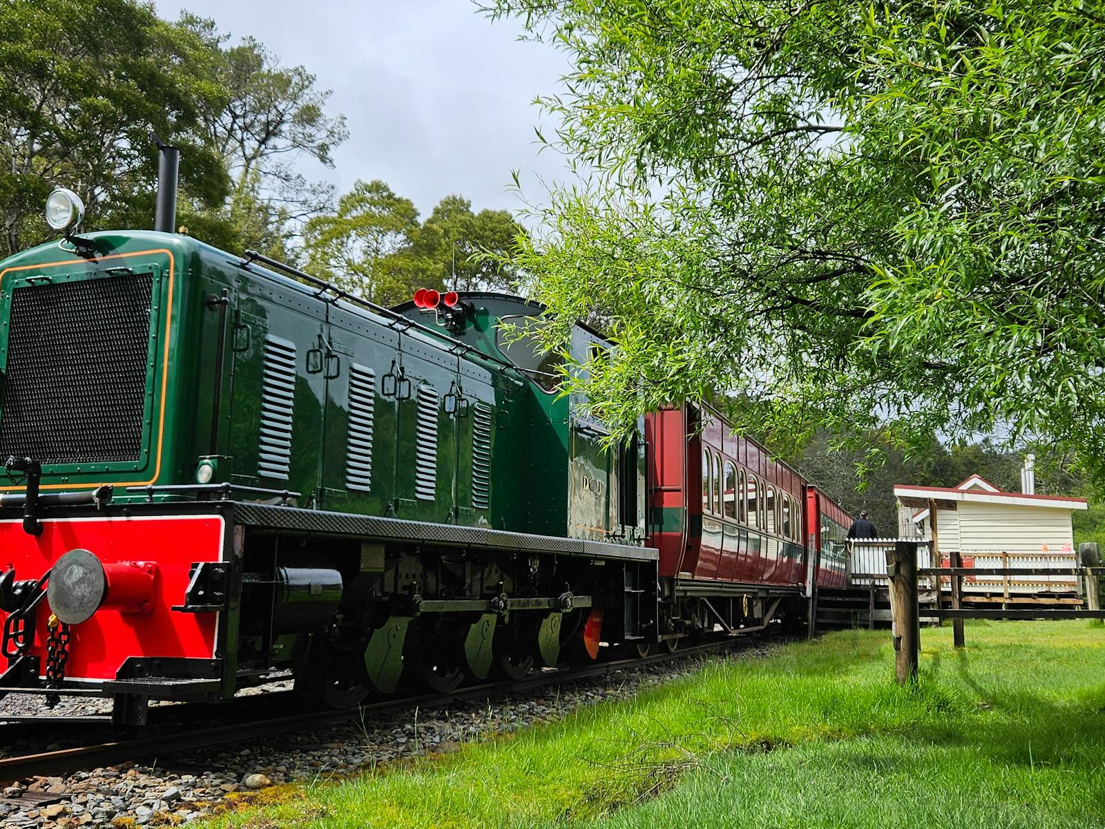 A heritage diesel locomotive sits at a remote bush station