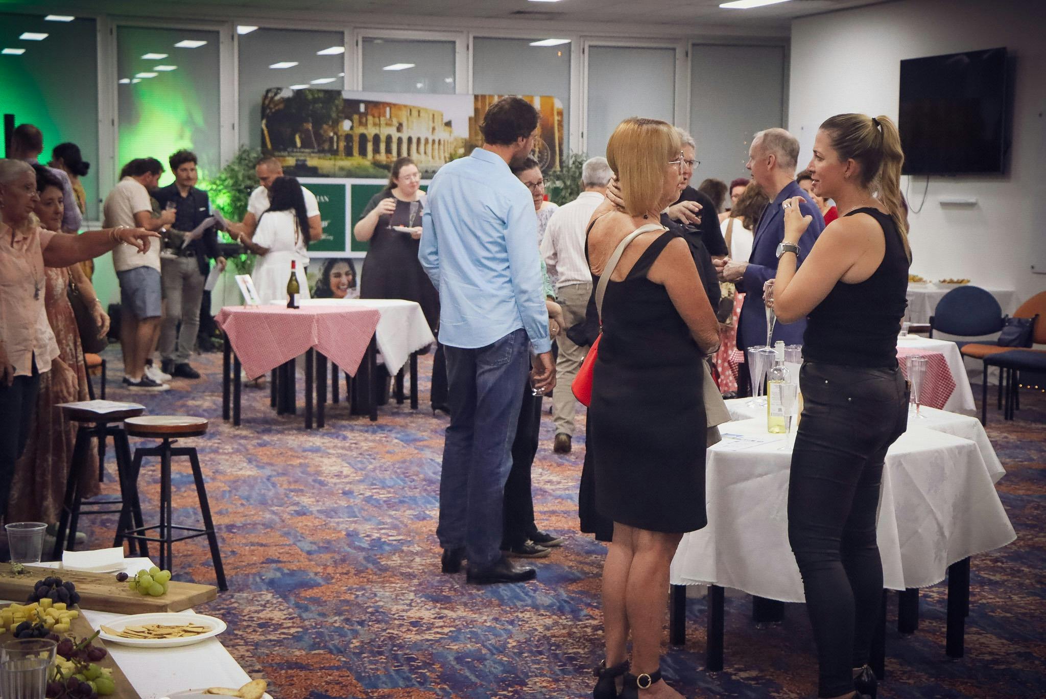 guests gathering around tables tasting wine and cheese
