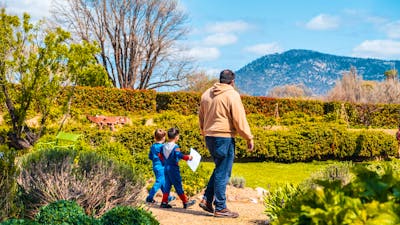 An adult and two children explore the gardens at Lanyon Homestead