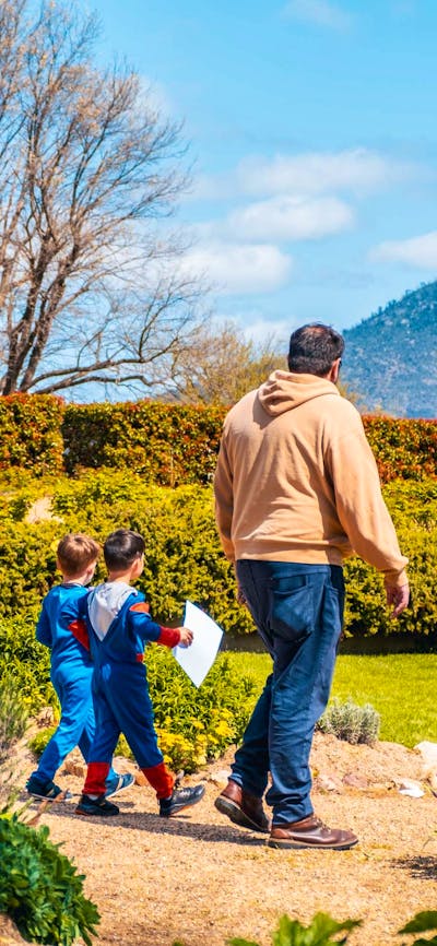 An adult and two children explore the gardens at Lanyon Homestead