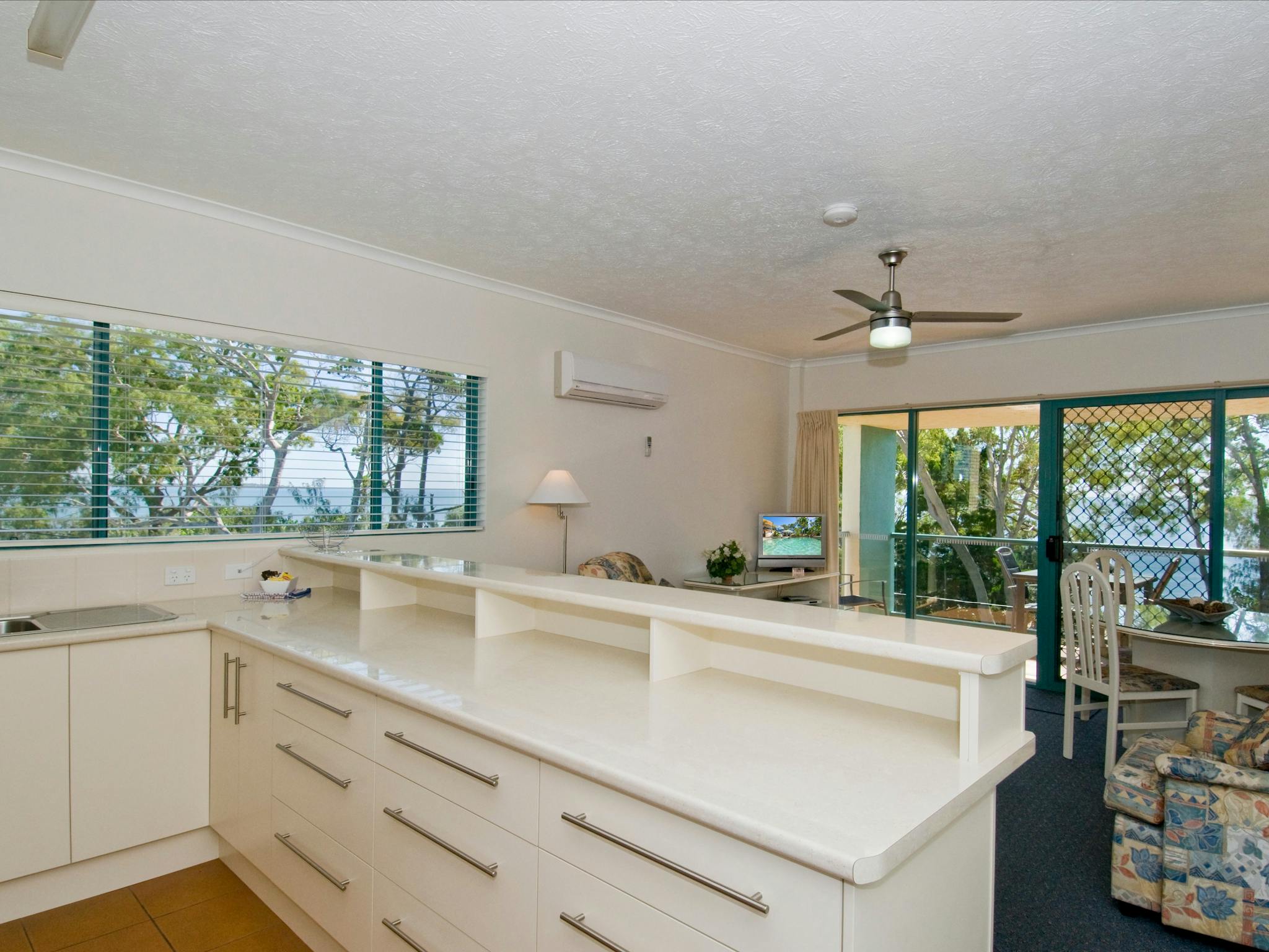 Kitchen with full size refrigerator, oven and cooktop and combined dining & lounge area Kitchen with full size refrigerator, oven and cooktop and combined dining & lounge area