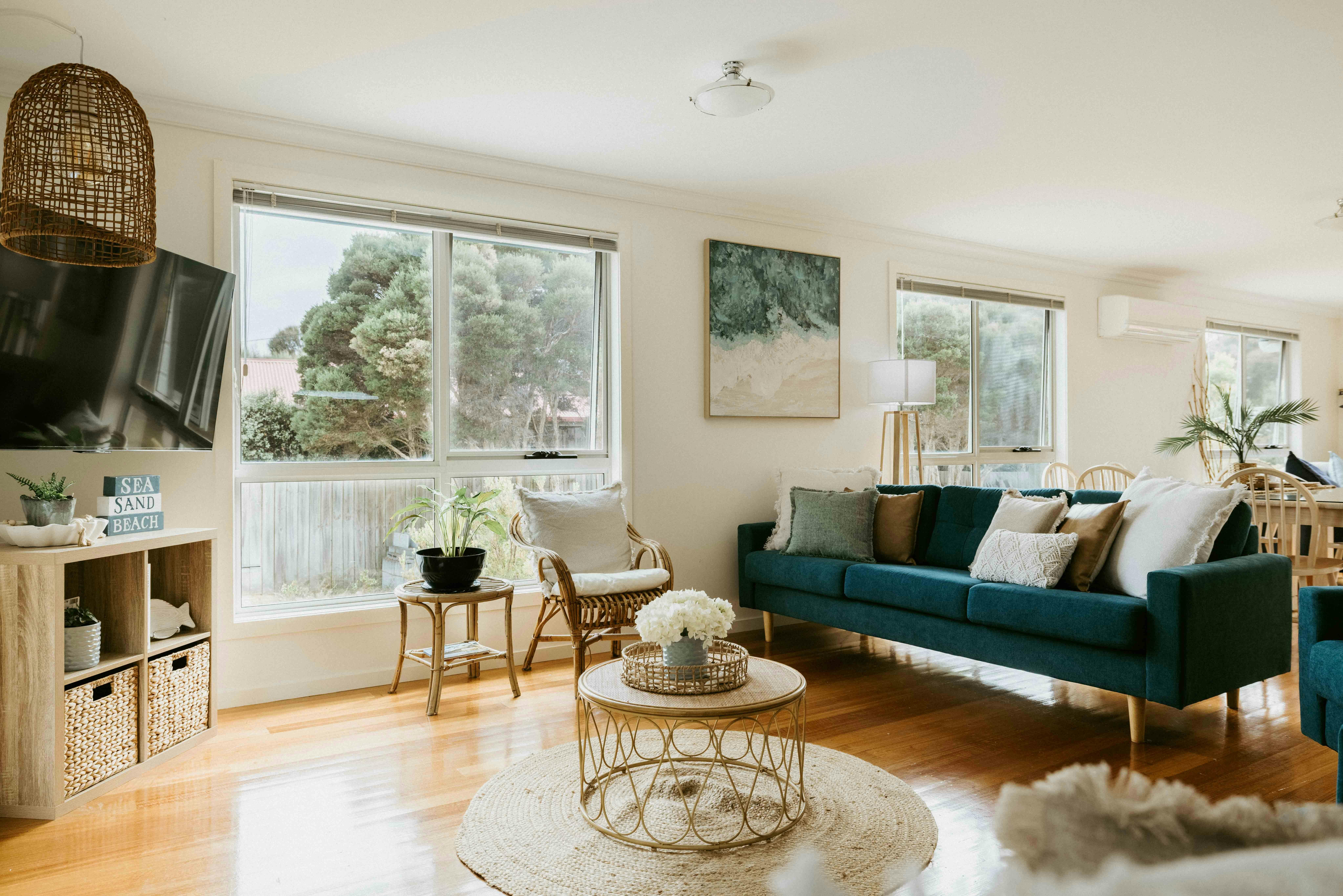 The main living room offers a perfect place to unwind, featuring a smart TV and plenty of seats.