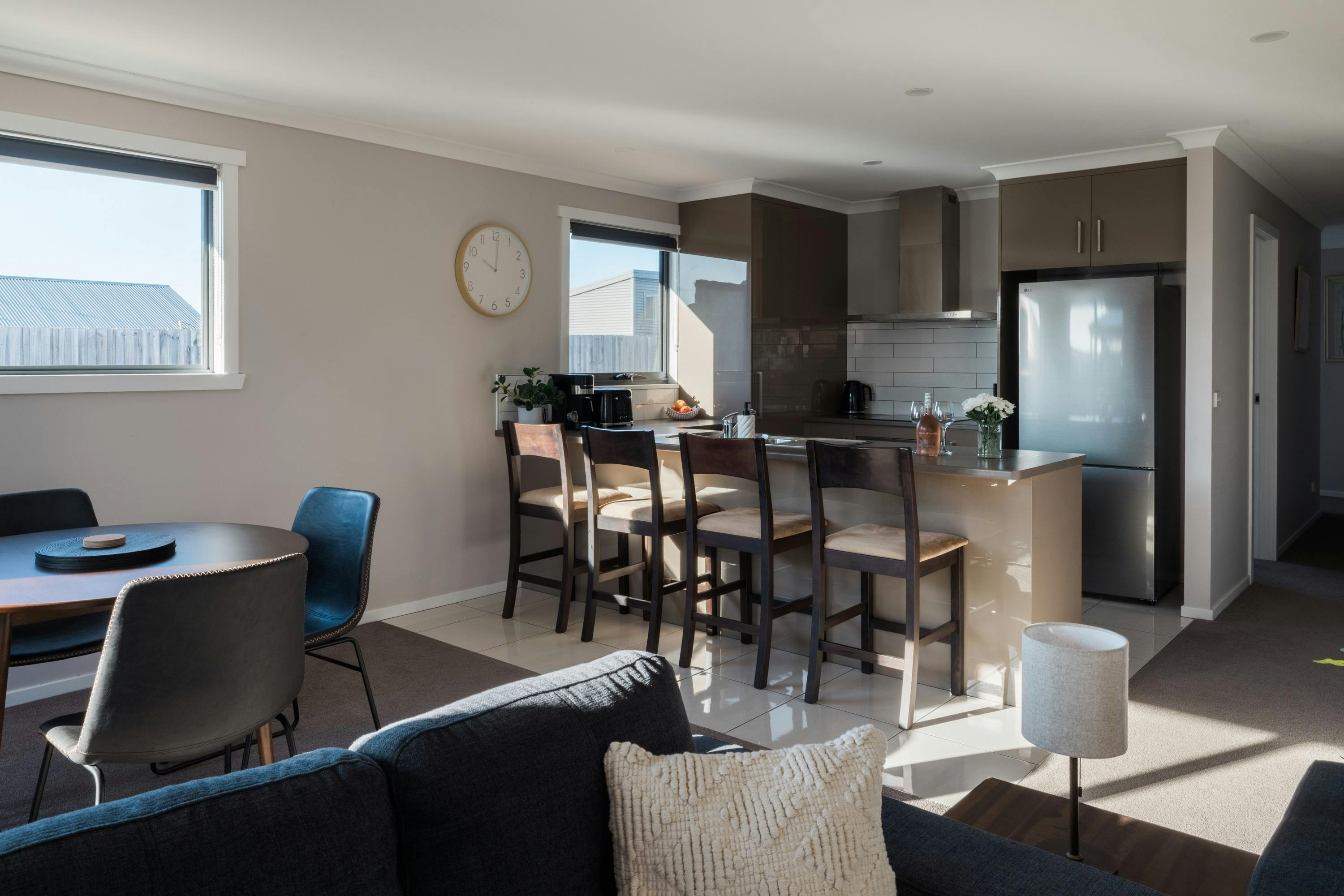 This open-plan kitchen and dining area is modern and fully equipped with brand-new appliances.