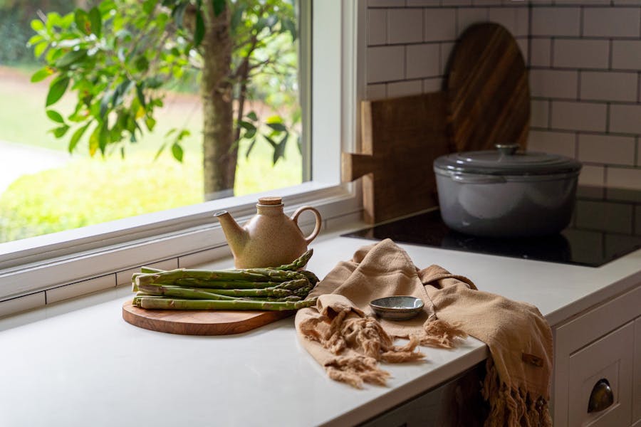 Some kitchen items lay on the bench in a lovely luxury kitchen