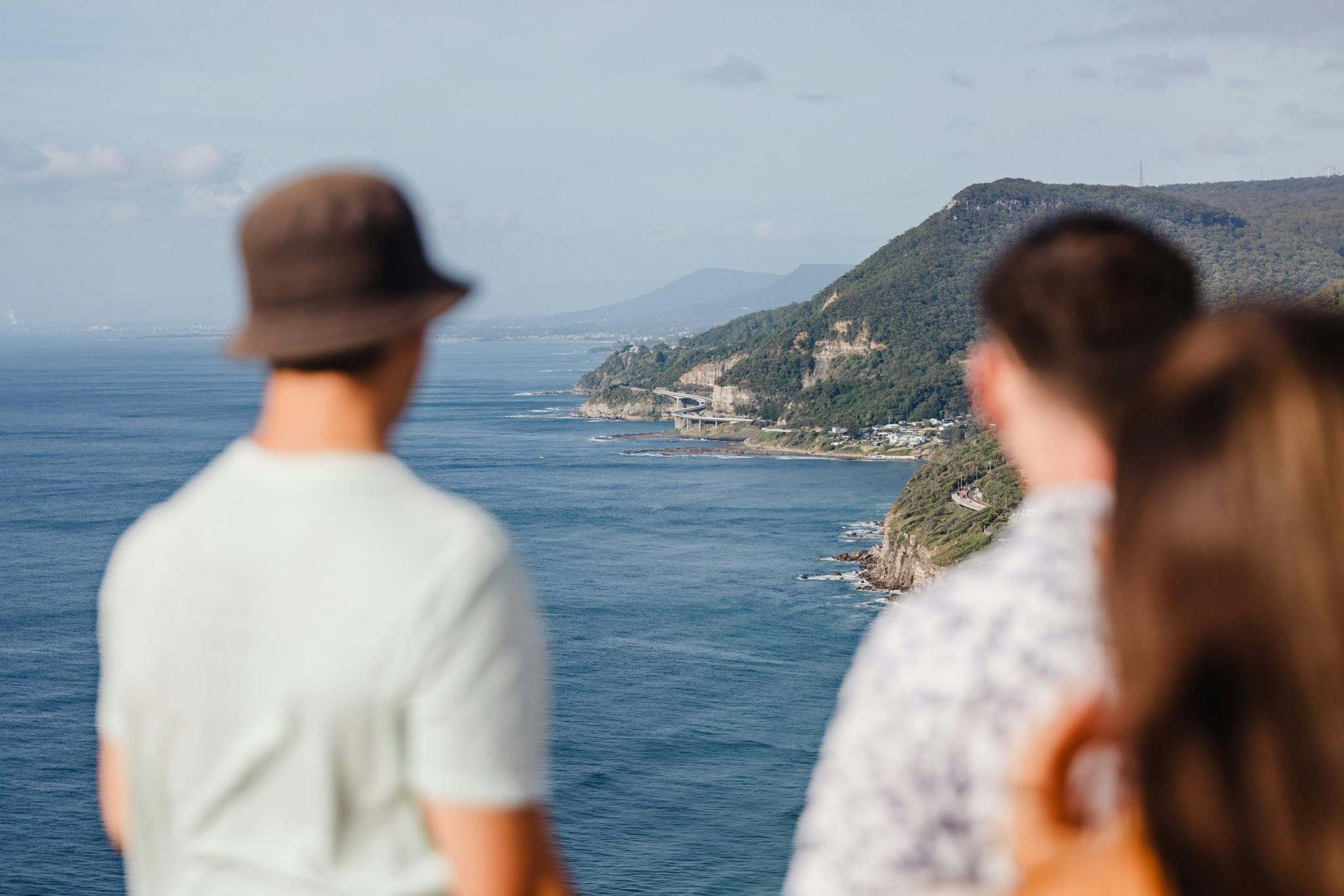 Two people with the ocean in the background from a viewpoint