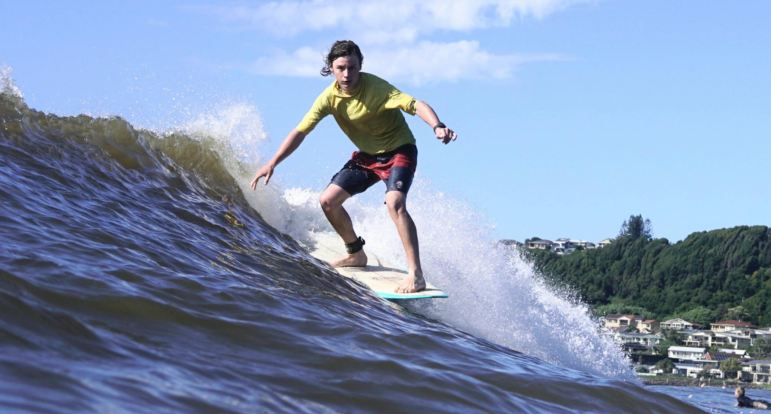 Longboarder surfing wave