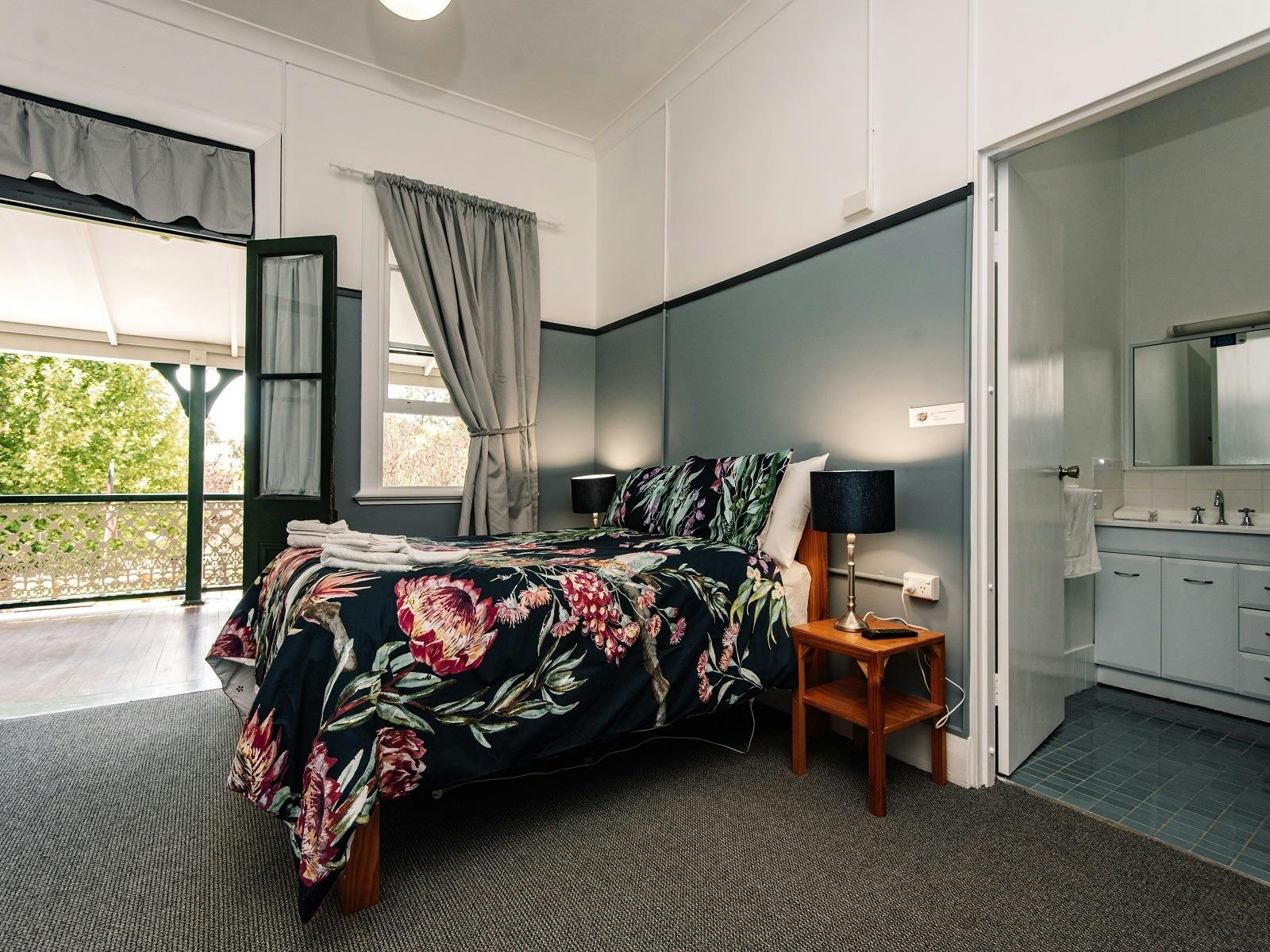 Photo showing the bed and entrance to the ensuite and show access to the verandah