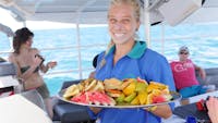 Serving fresh fruit platter on sail back from the Great Barrier Reef & Green Island on Ocean Free
