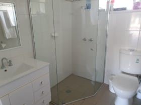 Large Bathroom with vanity, corner shower and toilet