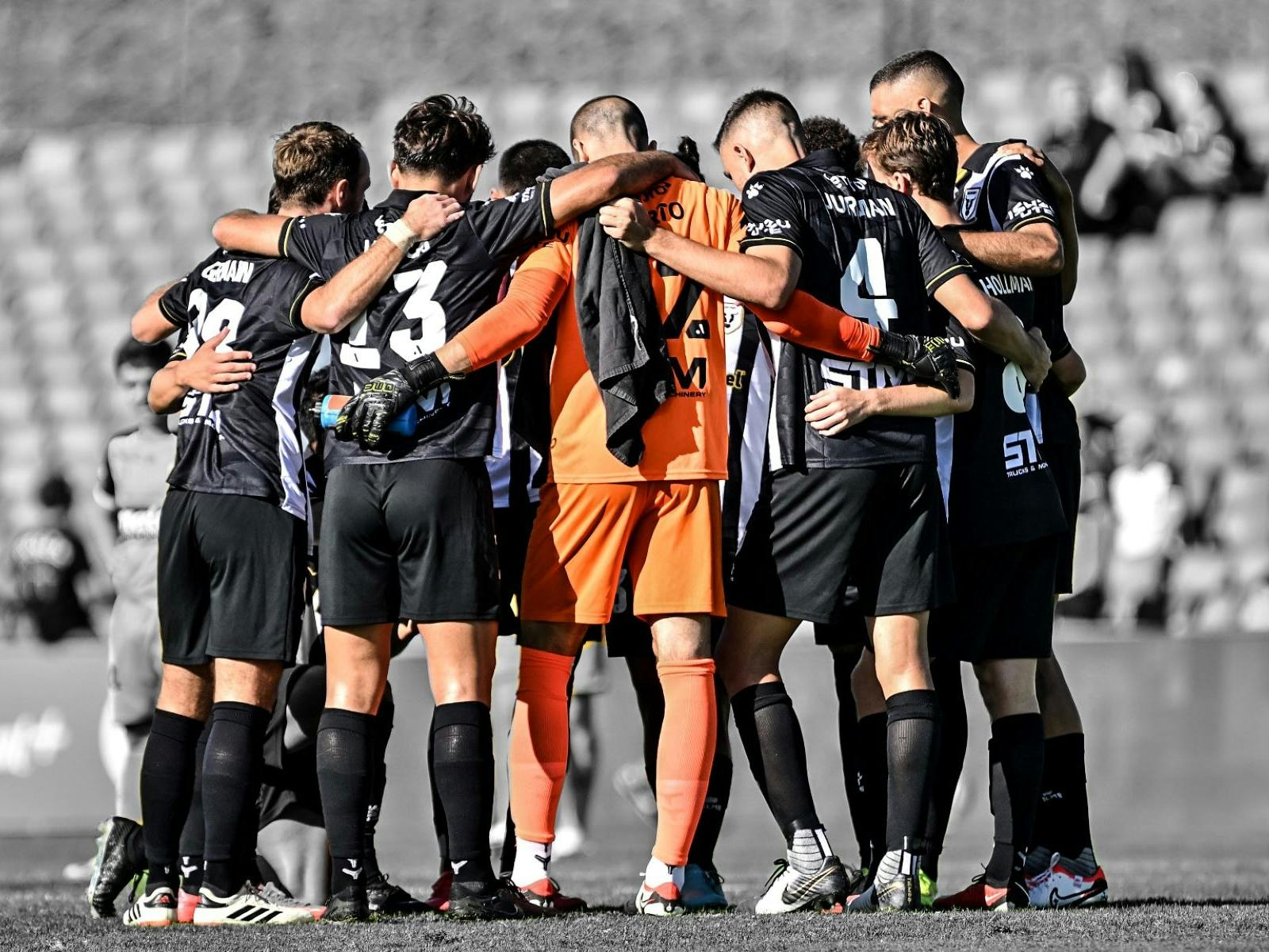 macarthur fc players in a huddle