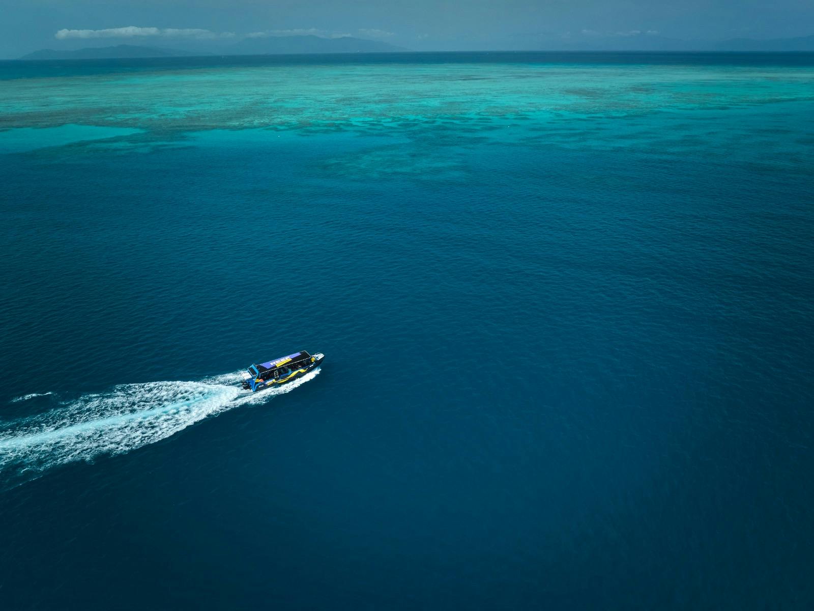 A Birds Eye view of "Mad Max", fast boat streaming along the Great Barrier Reef
