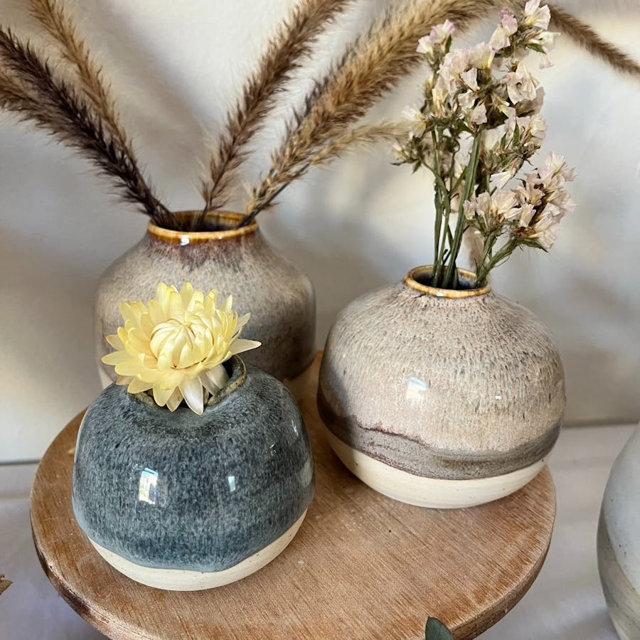 Images shows 3 vases on a table