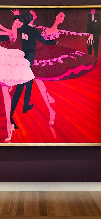 A person views a large painted portrait depicting people dancing, hanging on a gallery wall